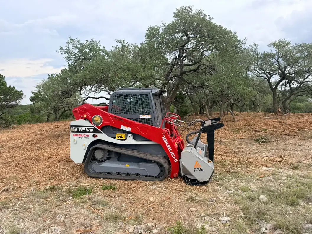Tracked mulcher on a freshly mulched hillside under live oaks near Florence, TX