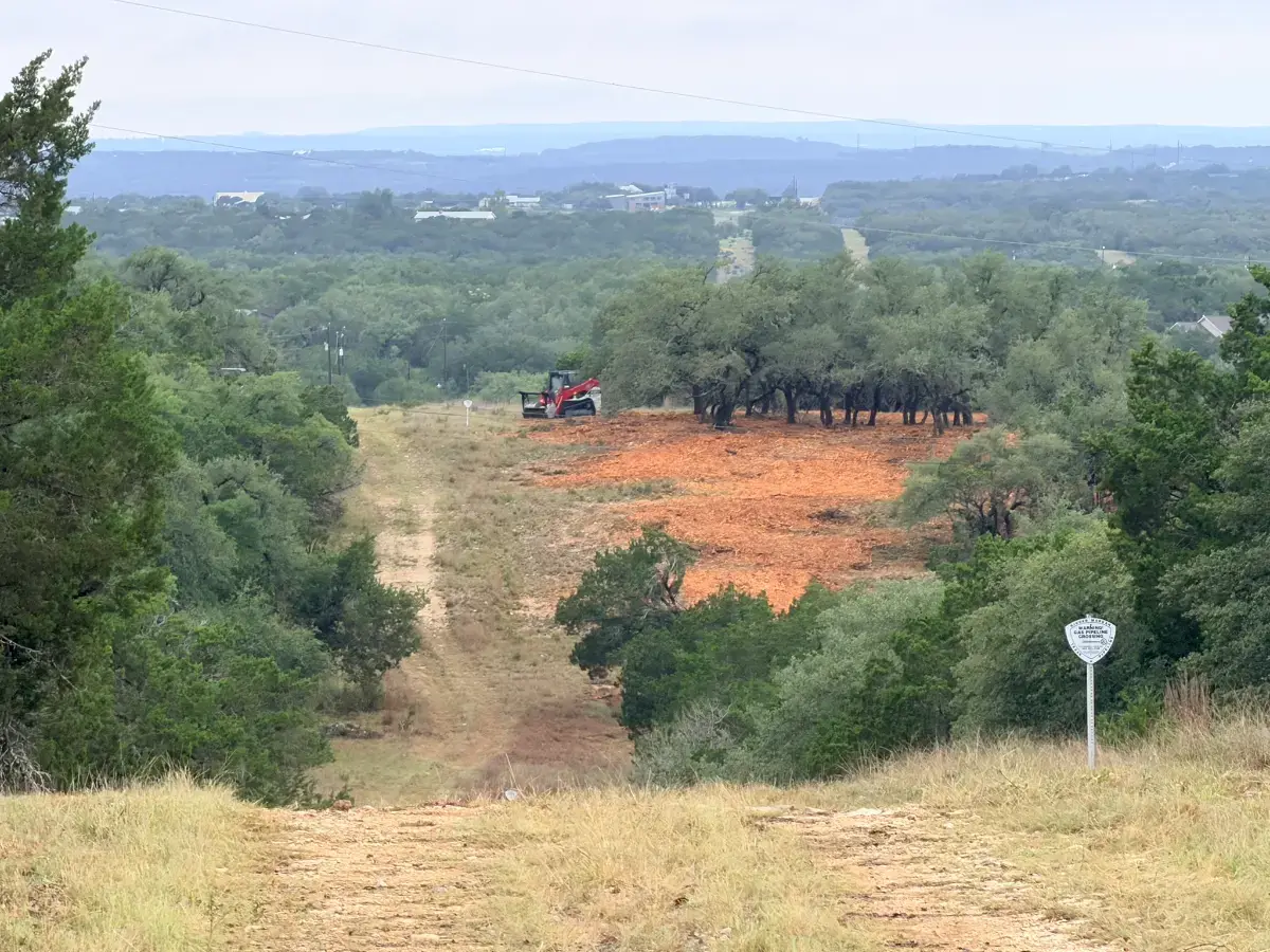 Mulched hillside below a ranch lane