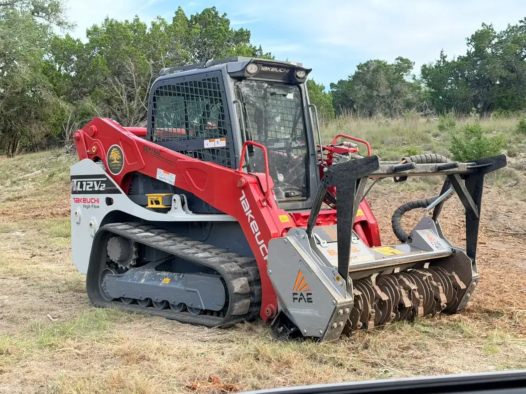 Takeuchi tracked loader with a forestry mulching head near Llano, TX